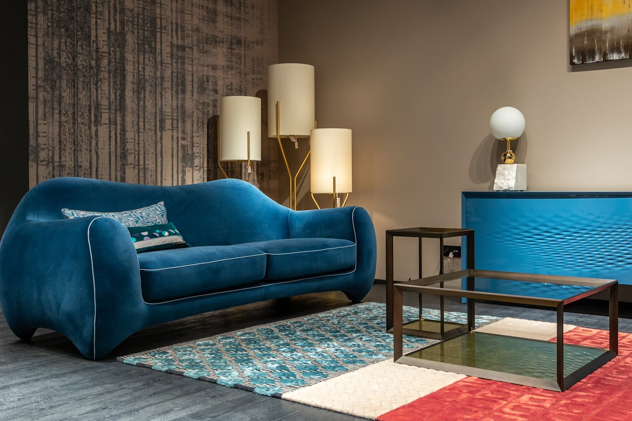 Elegant interior design featuring a blue sofa and contemporary decor elements.